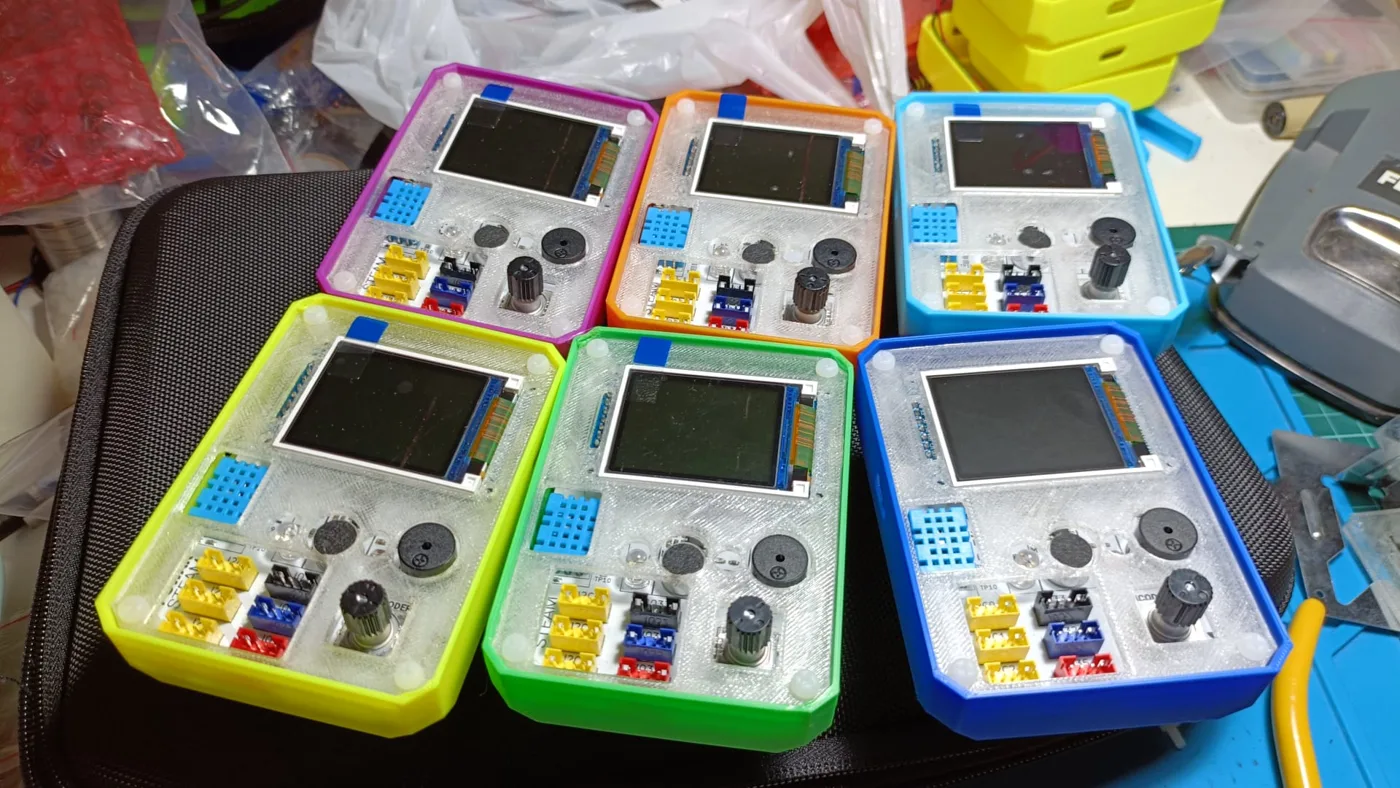 Six colourful P-Bit v3 units in their case, ready for the classroom